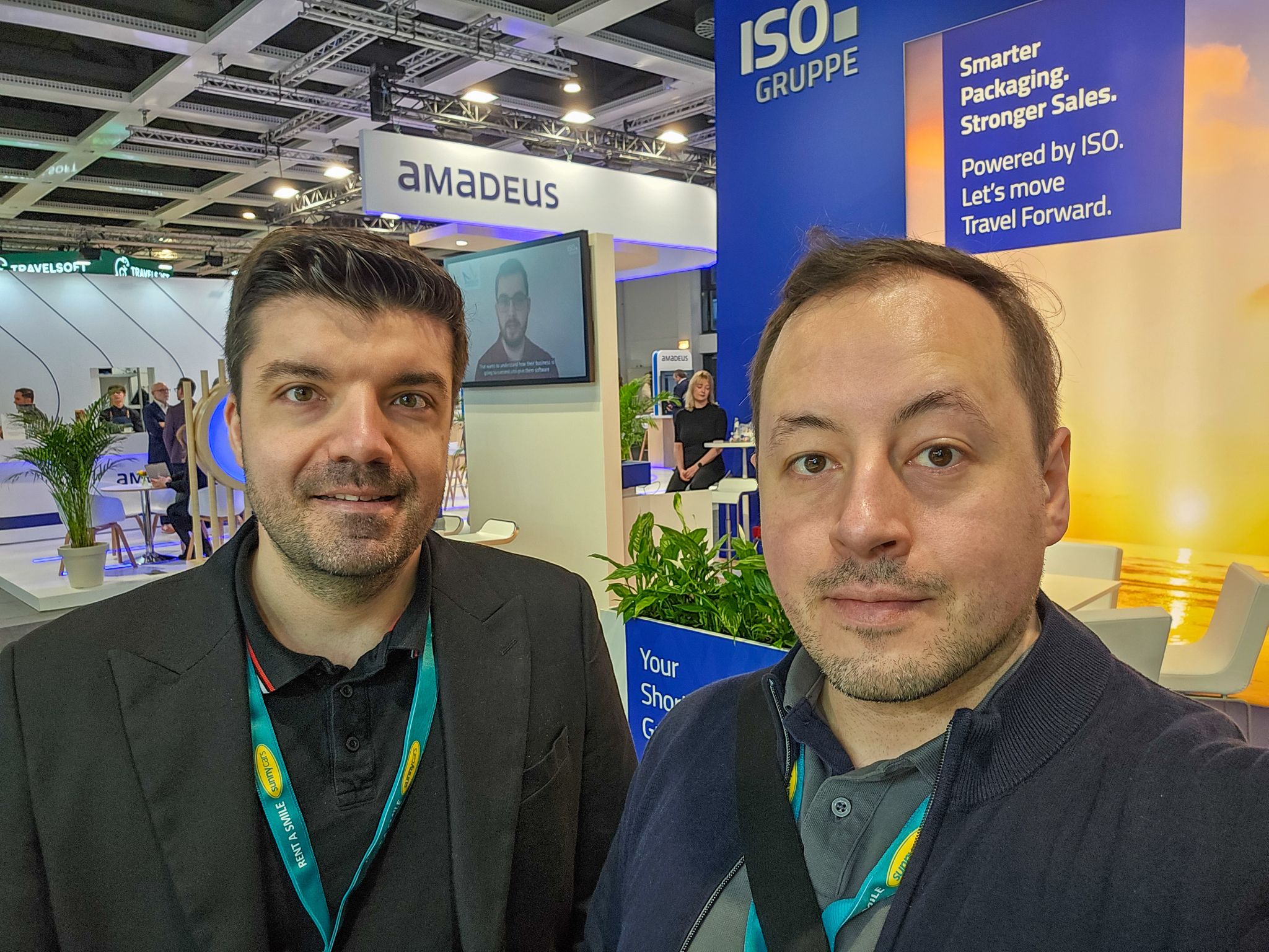 ITB Berlin participants in front of two exhibition stands